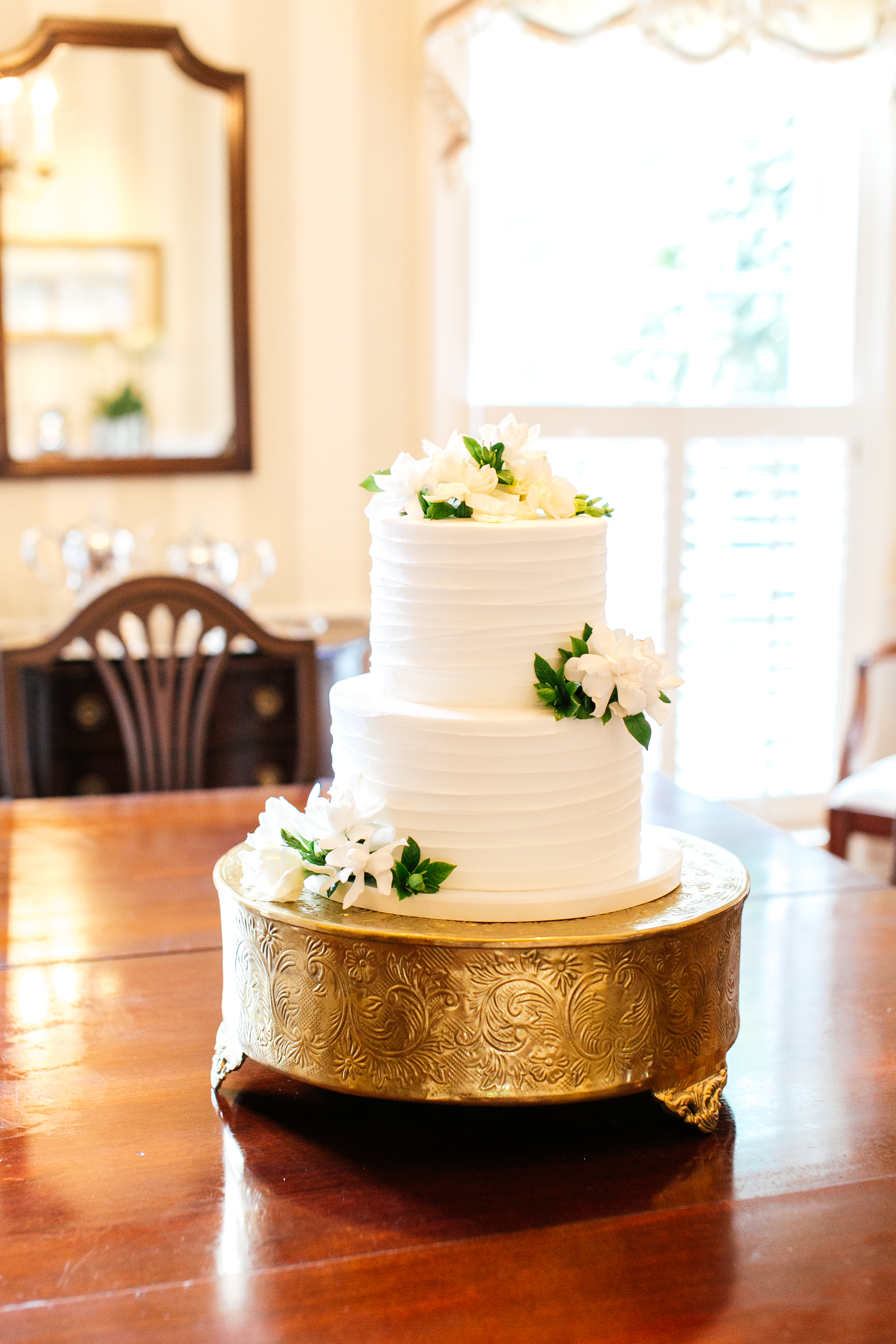 small micro wedding cake with gardenias